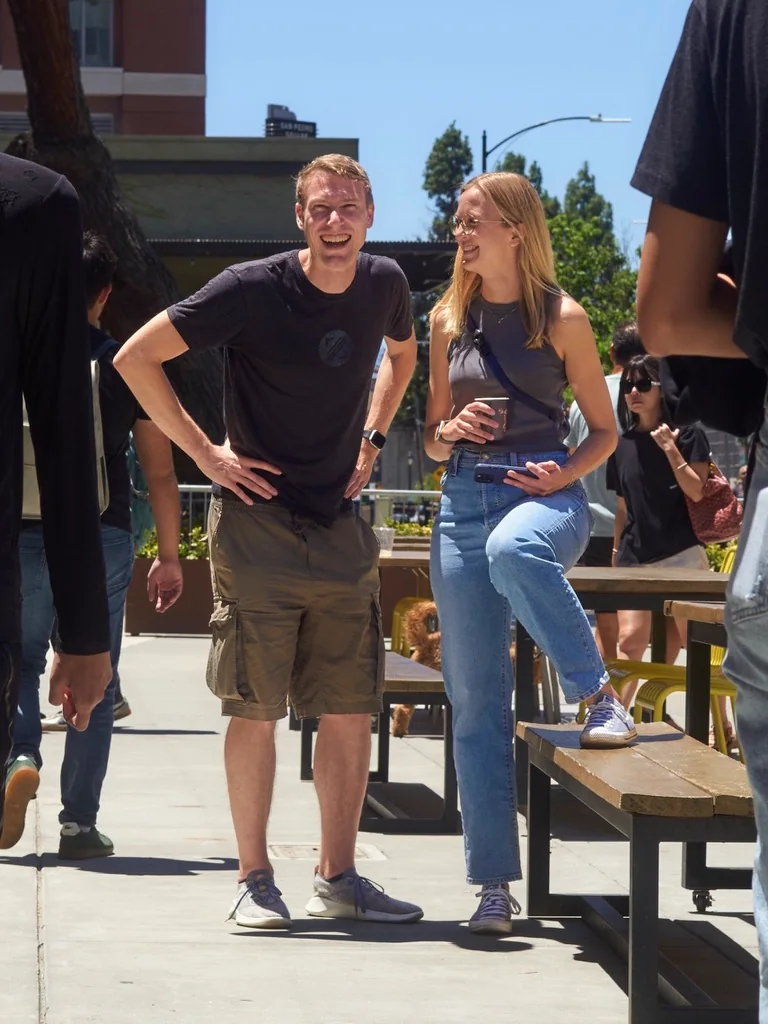 Kai and Malin laughing together outdoors